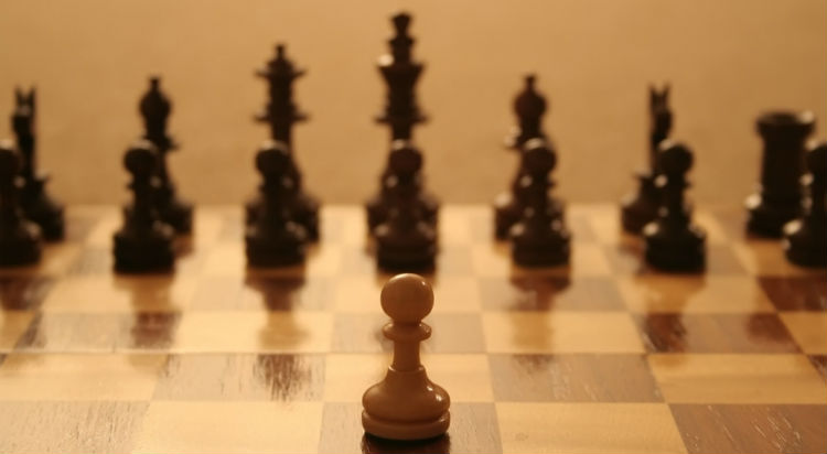 A Chess Pawn Infront Of A Chess Set