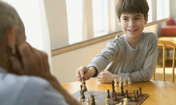 A Kid Plays Chess With An Adult