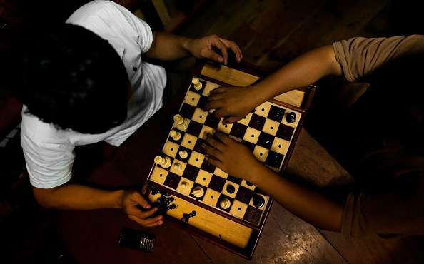 Two Blind Chess Players Playing Chess on a Braille Chess Set