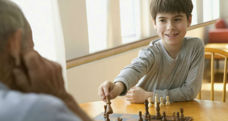 Chess game between a chess coach and a happy student